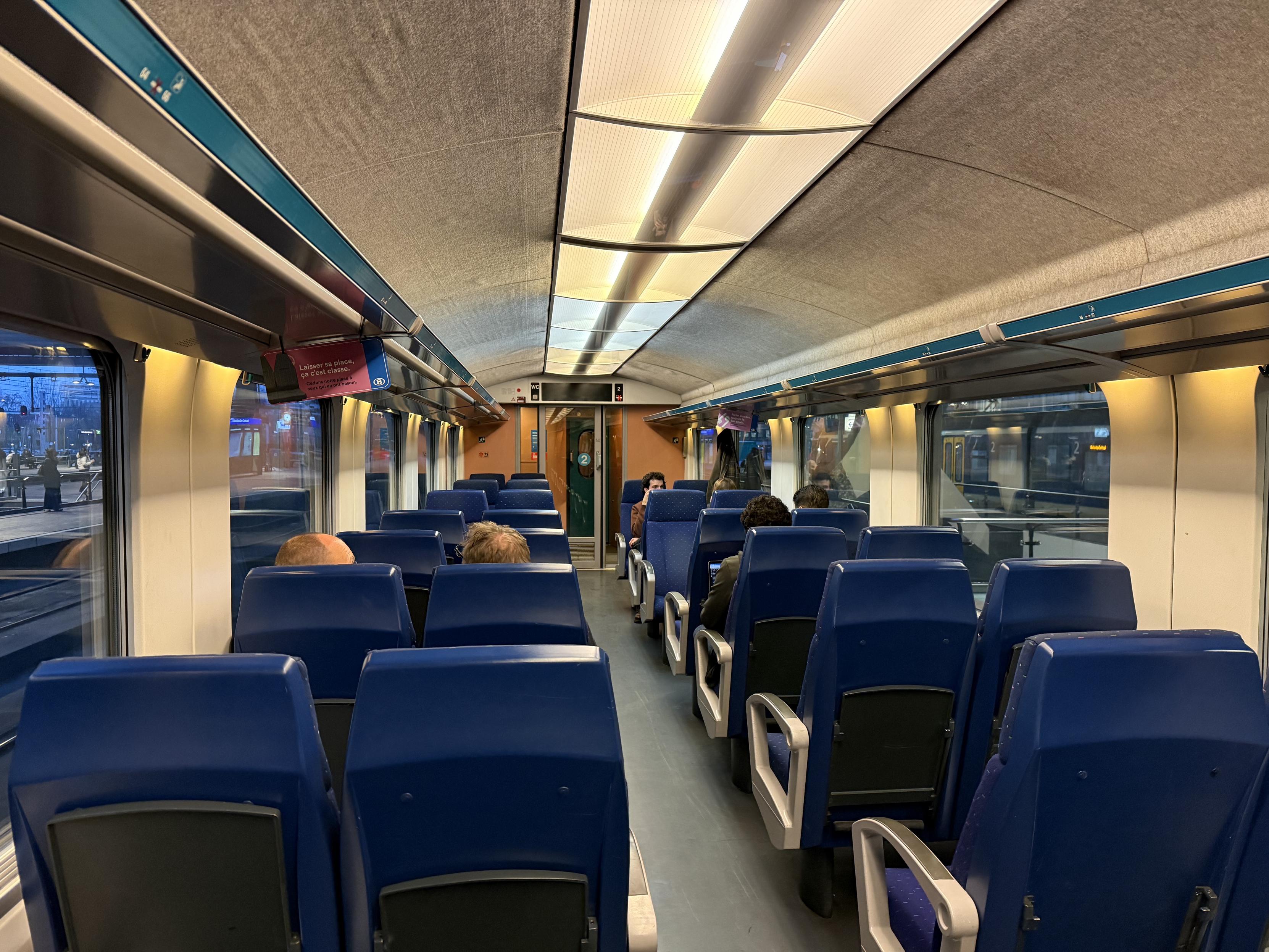 Interior of a Belgian train. Blue seats left and right.